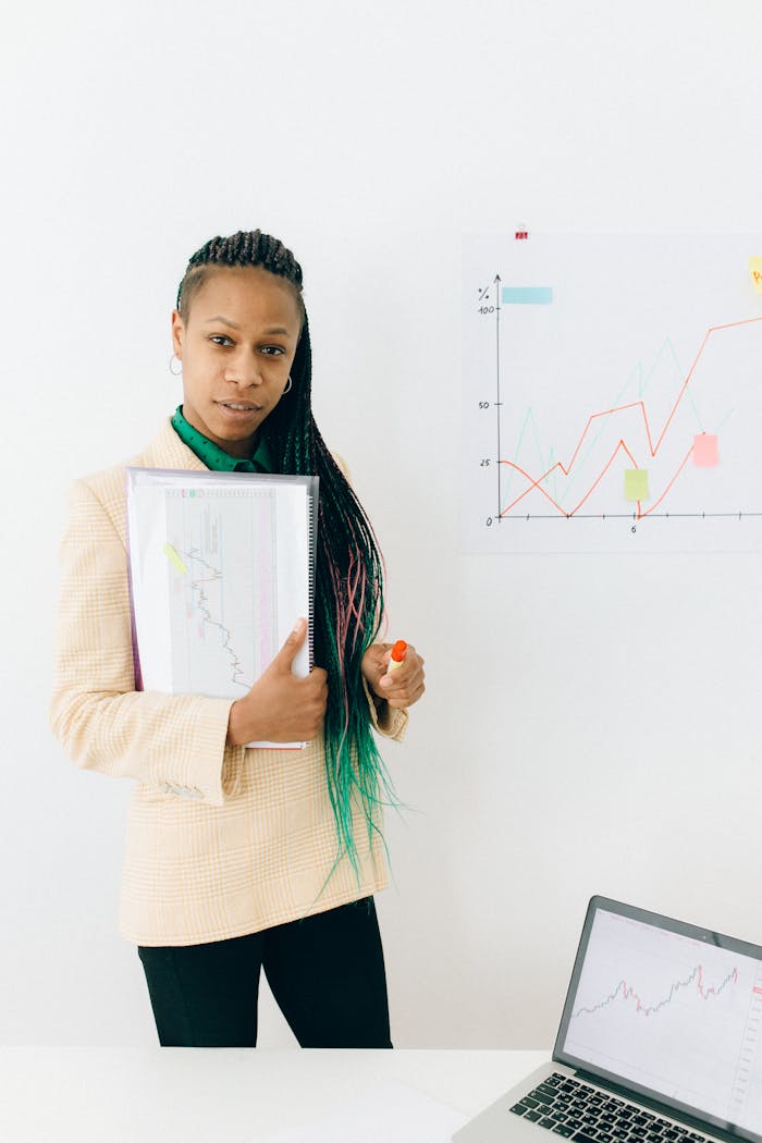 Woman in White Long Sleeve Shirt Holding White Paper